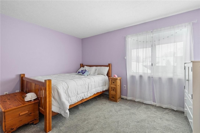 carpeted bedroom featuring a textured ceiling