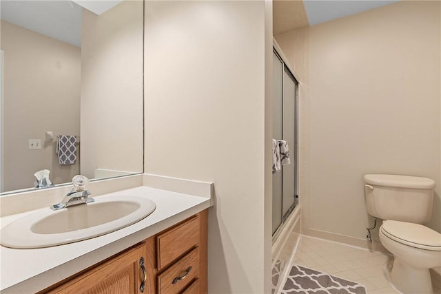 full bathroom with tile patterned flooring, vanity, toilet, and combined bath / shower with glass door