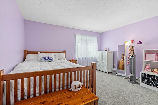 carpeted bedroom featuring a textured ceiling