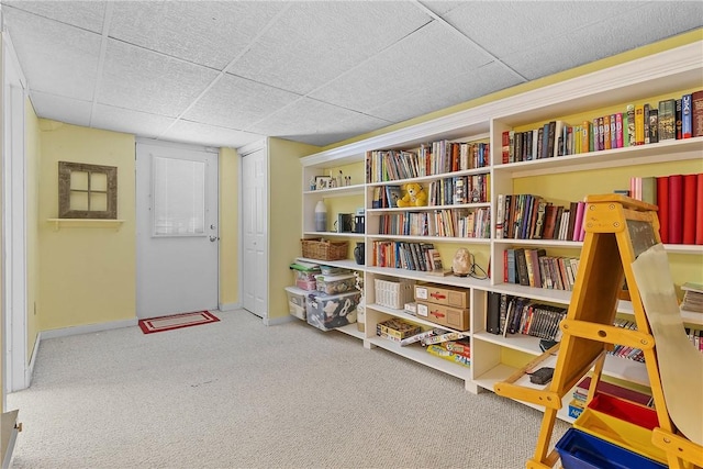 interior space featuring a paneled ceiling and carpet flooring