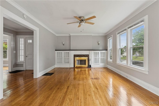 unfurnished living room with ceiling fan, ornamental molding, and wood-type flooring