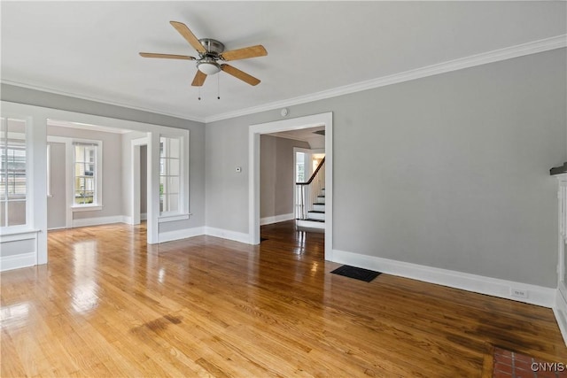 unfurnished room with ceiling fan, ornamental molding, and hardwood / wood-style floors