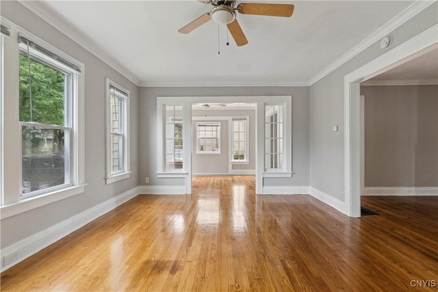 unfurnished living room with hardwood / wood-style floors, crown molding, and ceiling fan