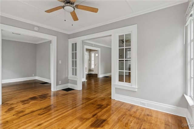 unfurnished room with hardwood / wood-style flooring, ornamental molding, and ceiling fan