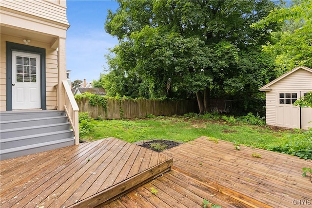 wooden terrace with a yard and a shed