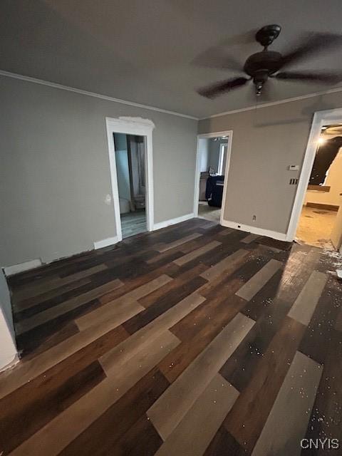 empty room featuring crown molding, ceiling fan, and dark hardwood / wood-style flooring