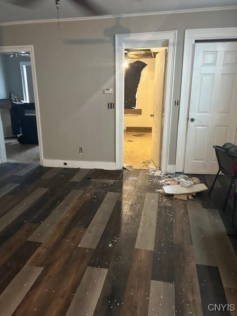 interior space with ornamental molding and dark wood-type flooring