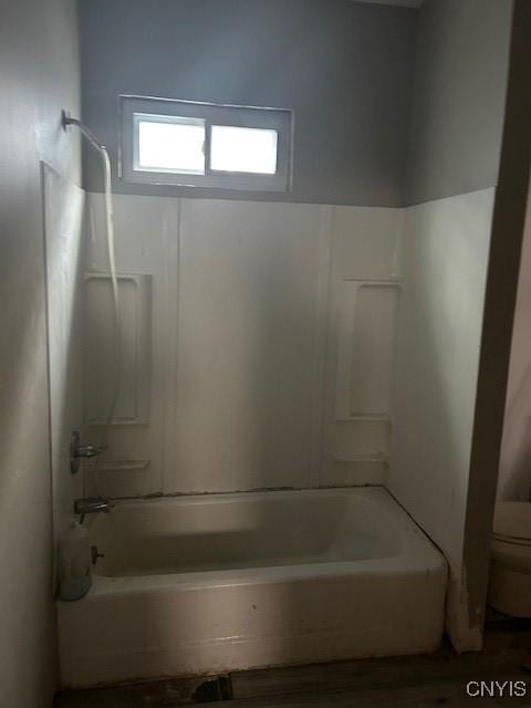 bathroom featuring toilet and washtub / shower combination