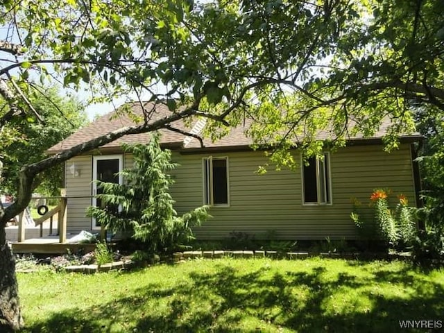 view of property exterior with a yard