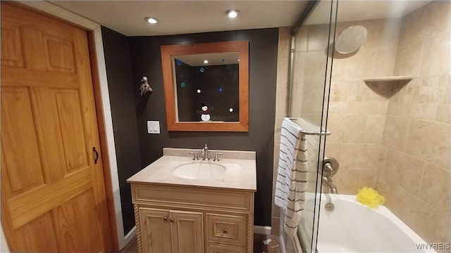 bathroom with vanity and tiled shower / bath combo