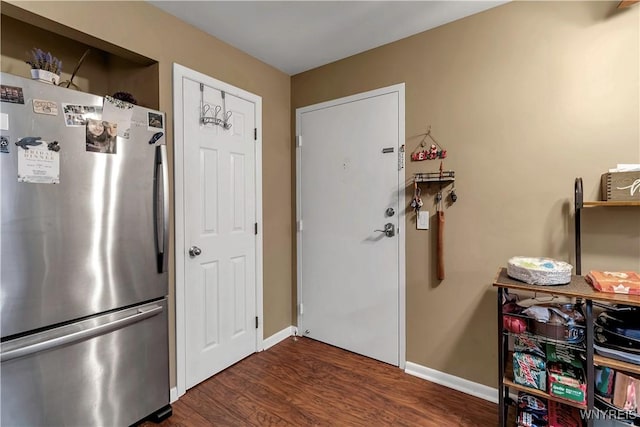 interior space with baseboards and dark wood-style flooring