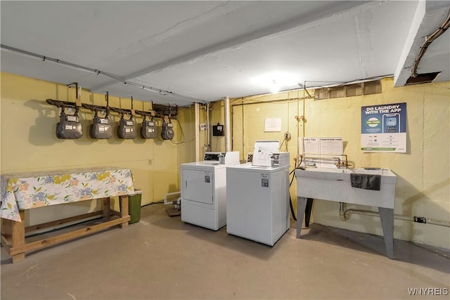 laundry room featuring laundry area, washer and dryer, and a sink