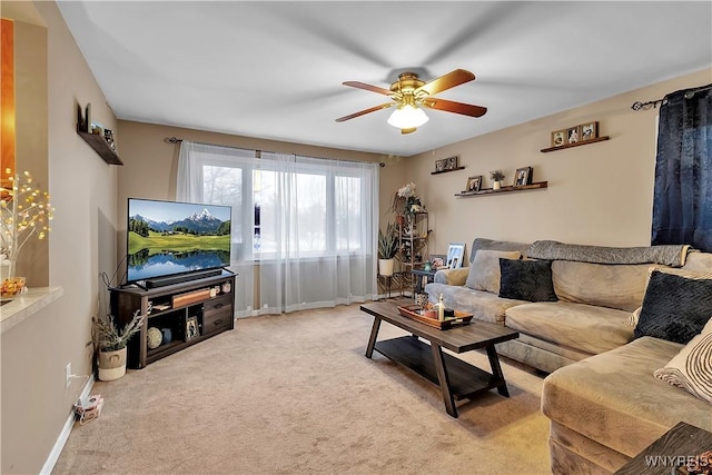 living room featuring baseboards, carpet floors, and ceiling fan