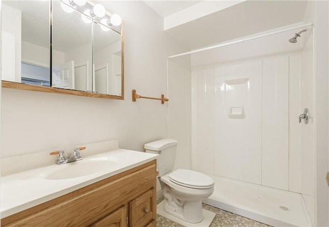 bathroom featuring walk in shower, vanity, and toilet