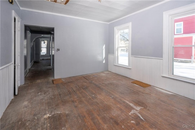 spare room featuring crown molding and dark hardwood / wood-style flooring