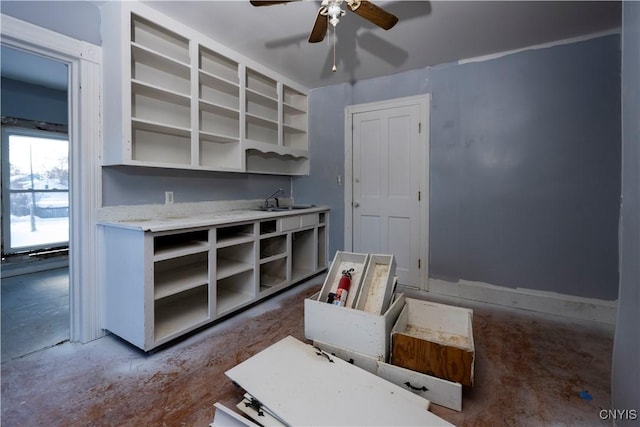 interior space with sink and ceiling fan