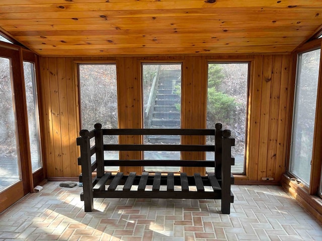 sunroom / solarium with wood ceiling and lofted ceiling