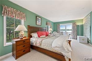 bedroom featuring light carpet