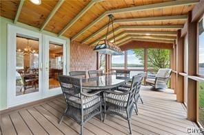 sunroom featuring wood ceiling, vaulted ceiling, and a chandelier