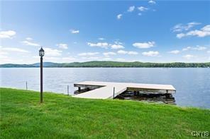 view of dock featuring a water view and a lawn