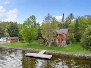 dock area featuring a water view and a yard