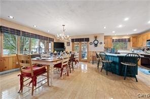 dining space featuring a notable chandelier and light wood-type flooring