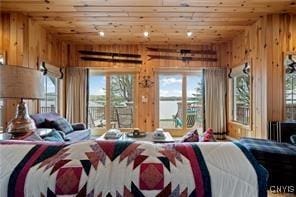 bedroom with wooden walls and wooden ceiling