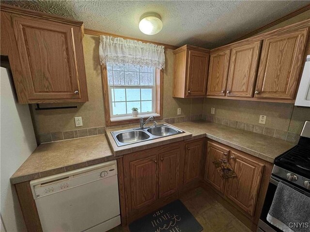 kitchen with sink, white dishwasher, gas stove, and a textured ceiling