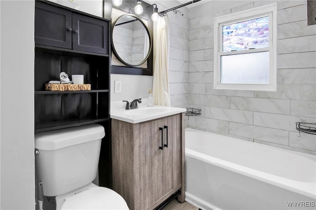 full bathroom featuring vanity, shower / tub combo, and toilet