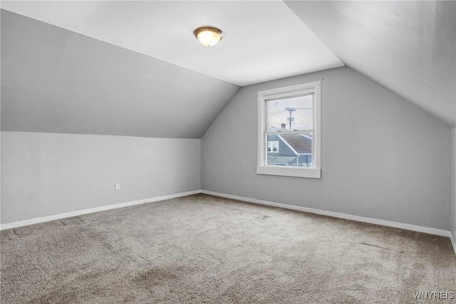 additional living space with lofted ceiling and carpet