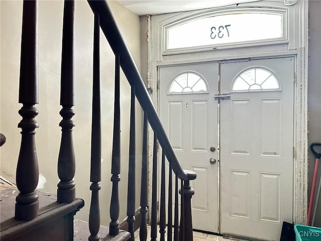 entryway featuring a wealth of natural light and stairs