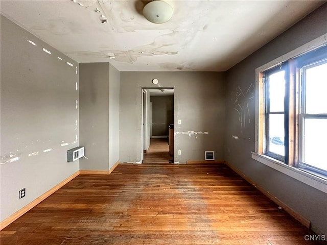 empty room with baseboards and light wood-style floors