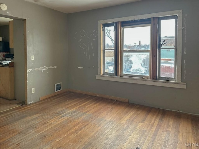 empty room featuring light wood-style floors and visible vents