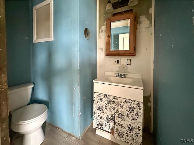 bathroom with tile patterned flooring, toilet, and vanity