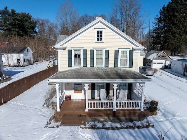 view of front property with a porch and an outdoor structure