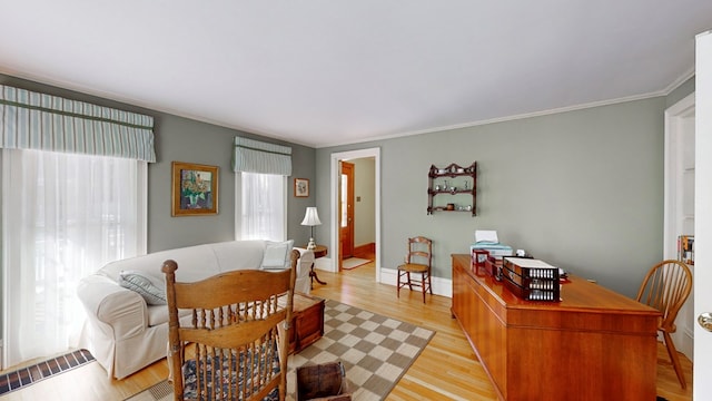 dining room featuring radiator, crown molding, plenty of natural light, and light wood-type flooring