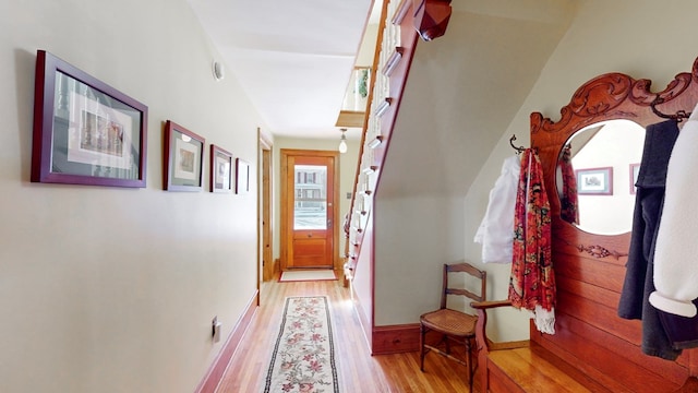 hallway with light hardwood / wood-style flooring