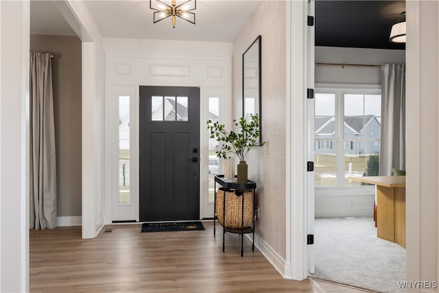 entrance foyer with a notable chandelier and hardwood / wood-style flooring