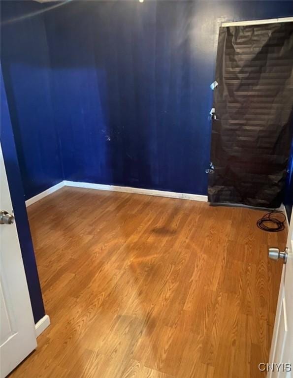 unfurnished room with hardwood / wood-style floors