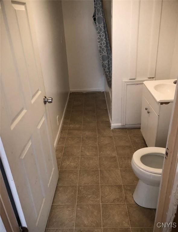 bathroom with tile patterned flooring, vanity, and toilet