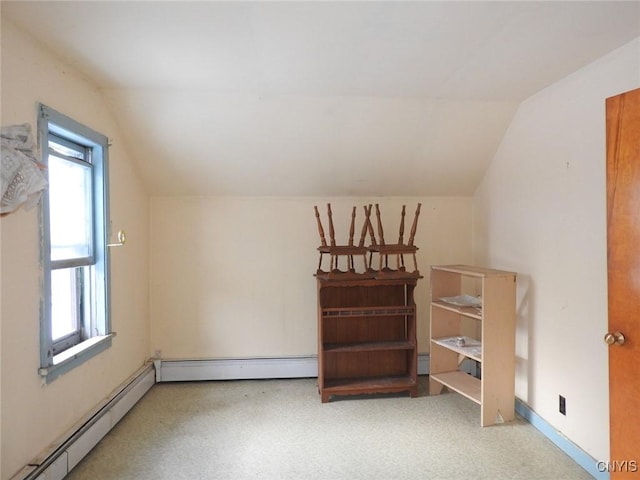 additional living space with lofted ceiling and a baseboard heating unit