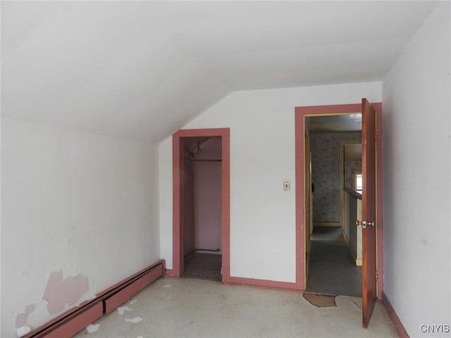 bonus room with vaulted ceiling and a baseboard heating unit