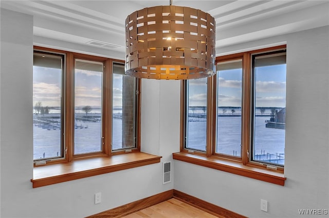 interior space featuring a water view and hardwood / wood-style floors