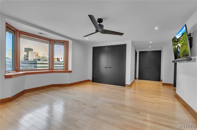 unfurnished bedroom featuring ceiling fan and light hardwood / wood-style flooring