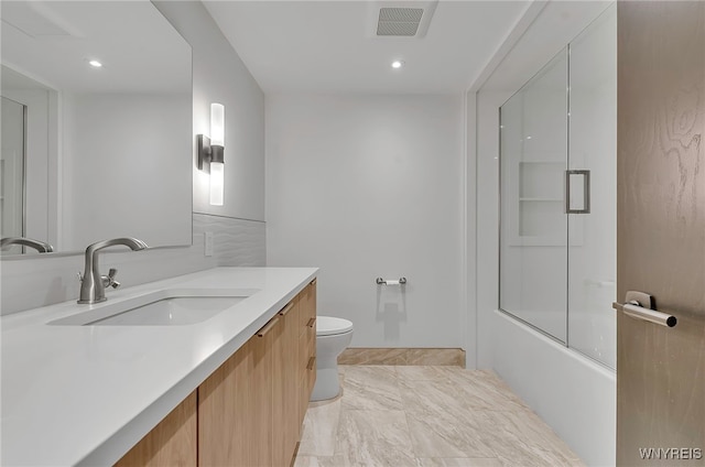 full bathroom with vanity, toilet, and combined bath / shower with glass door