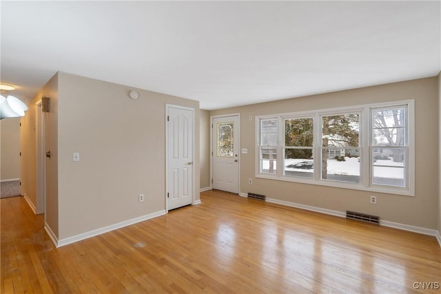 empty room with light hardwood / wood-style floors