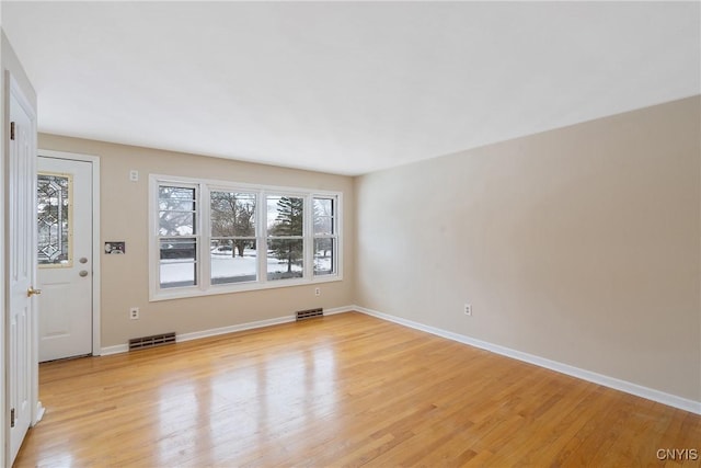 spare room with light hardwood / wood-style floors