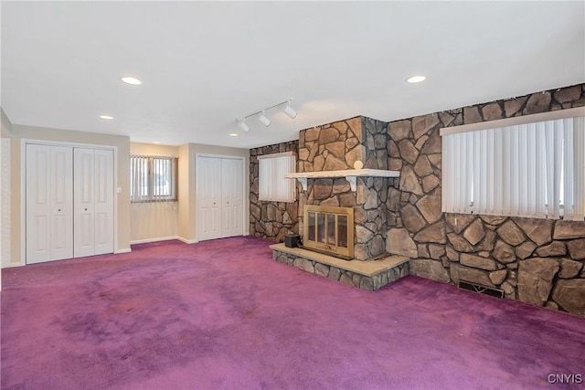 unfurnished living room with a fireplace and carpet flooring