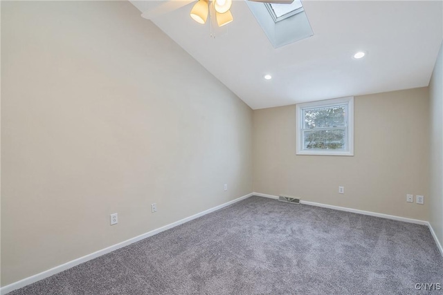 carpeted spare room with vaulted ceiling and ceiling fan