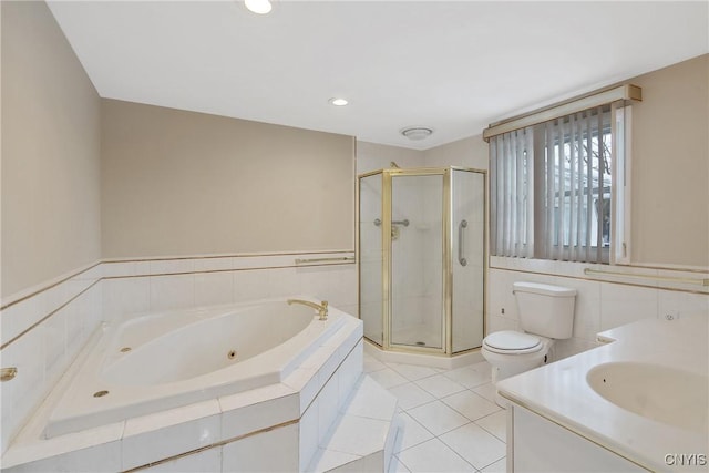 full bathroom featuring tile patterned flooring, tile walls, separate shower and tub, vanity, and toilet